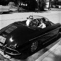 Steve McQueen and Neile Adams Smiling in Porsche